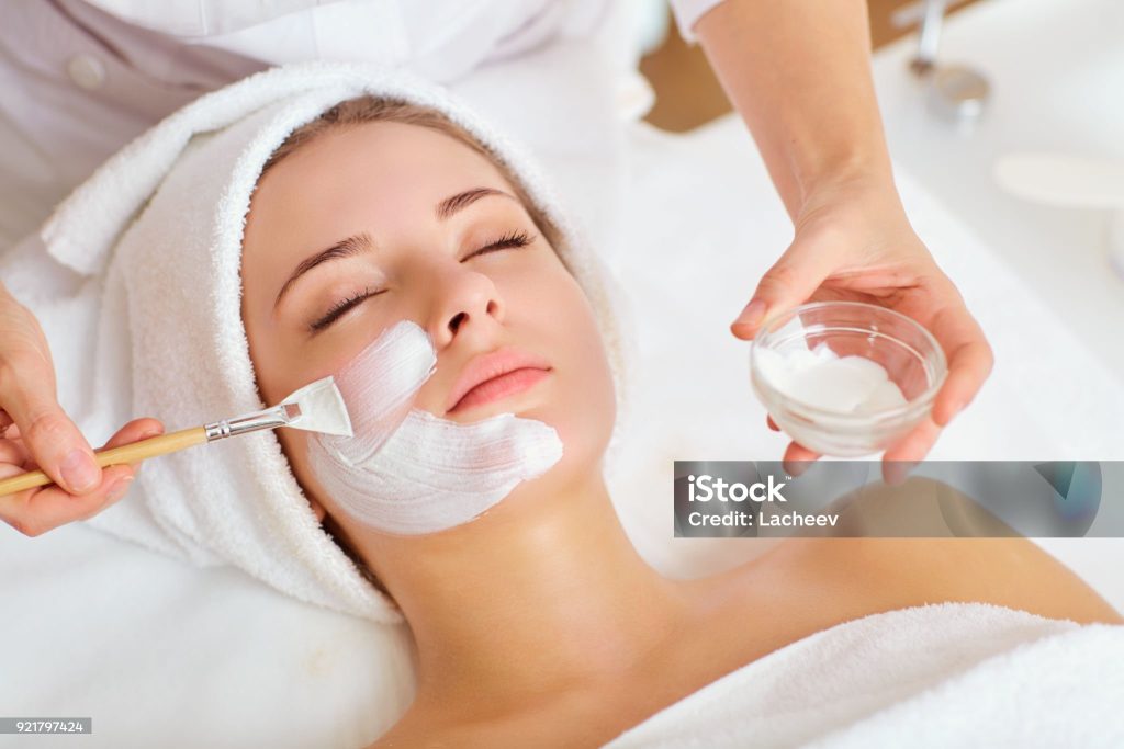 woman in mask on face in spa beauty salon.